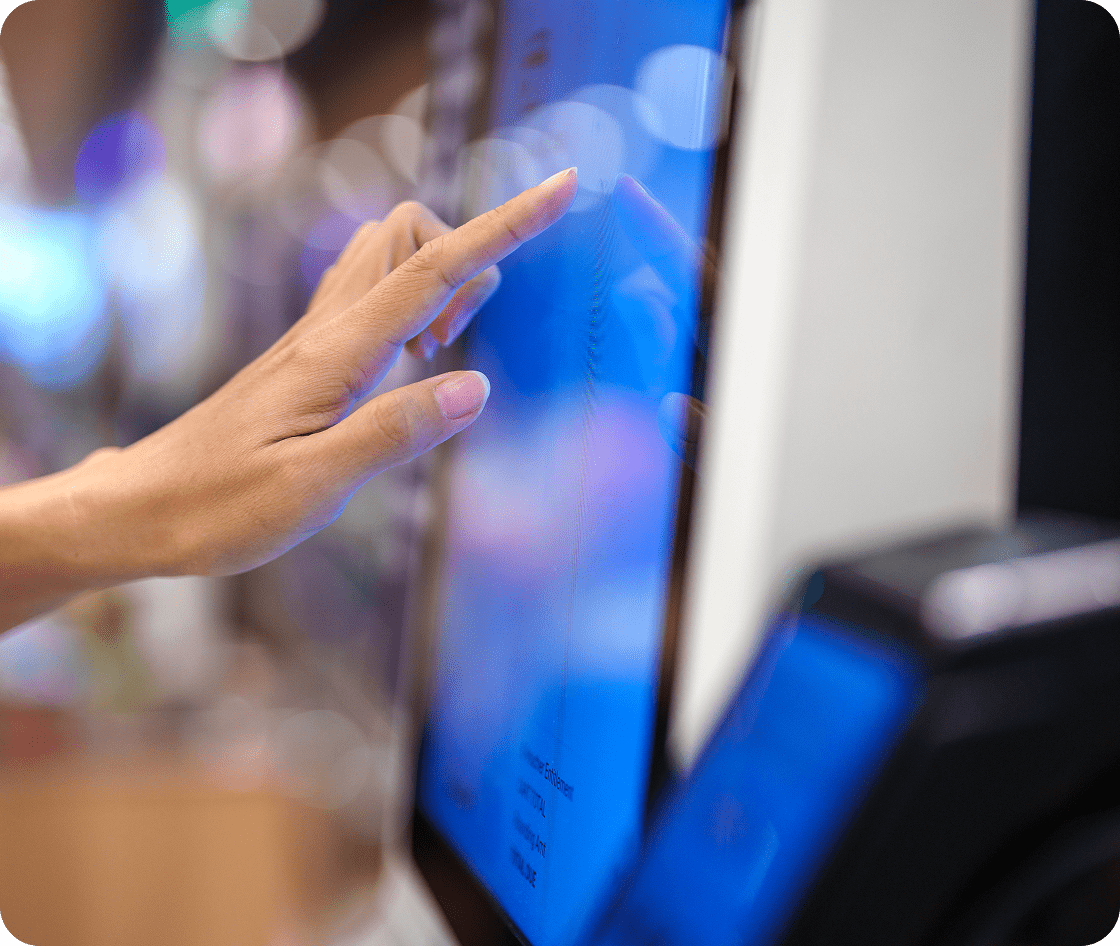 Hand touching a digital touchscreen