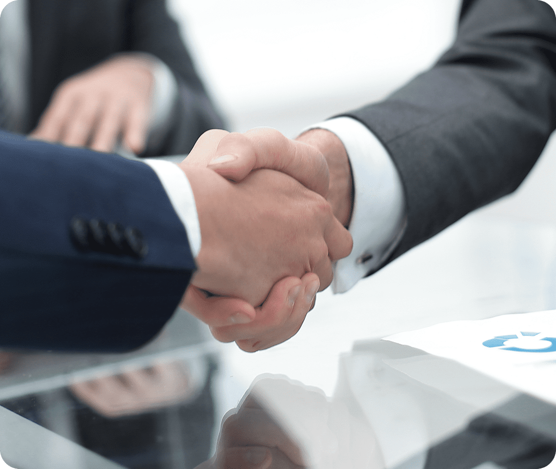 Two business professionals shaking hands in agreement.
