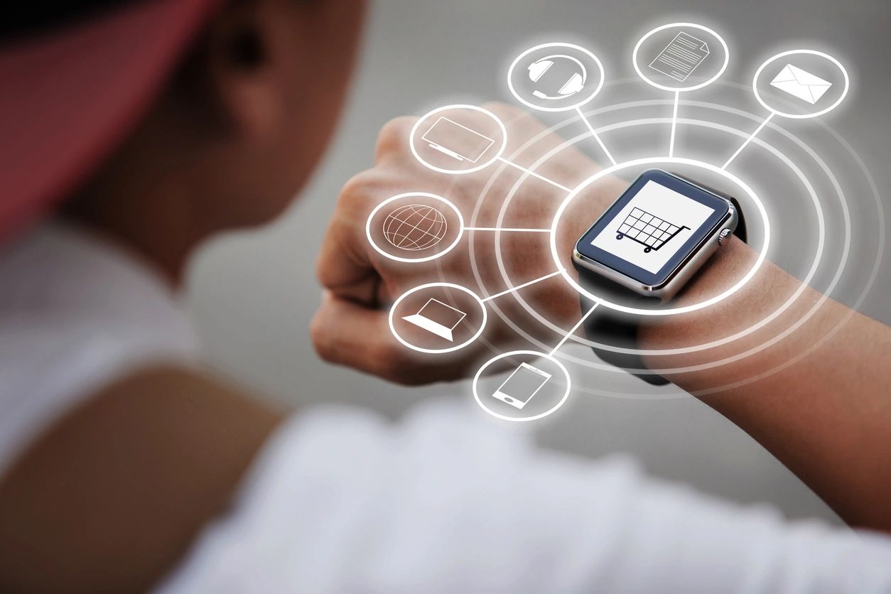 Person interacting with smartwatch displaying digital icons.