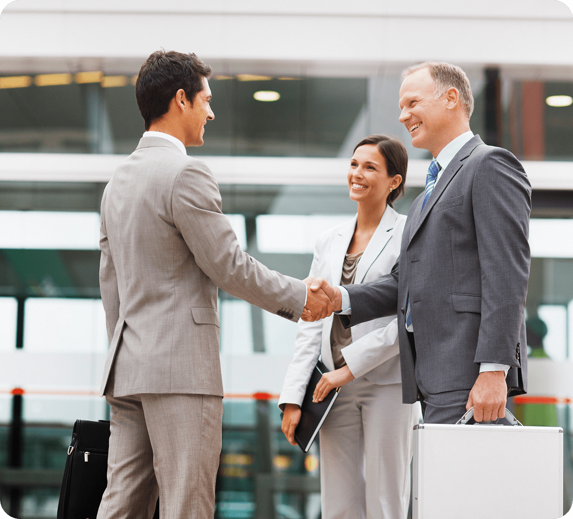 Business professionals shaking hands outdoors