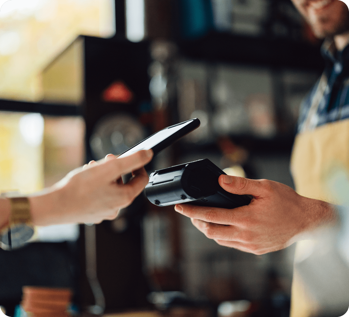 Cashier using card reader for payment