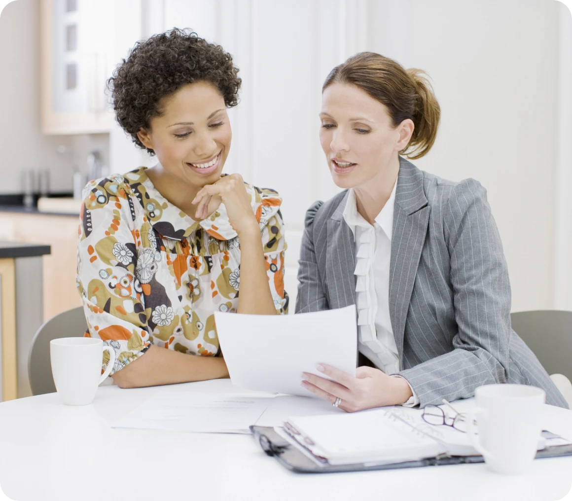Colleagues discussing paperwork at table