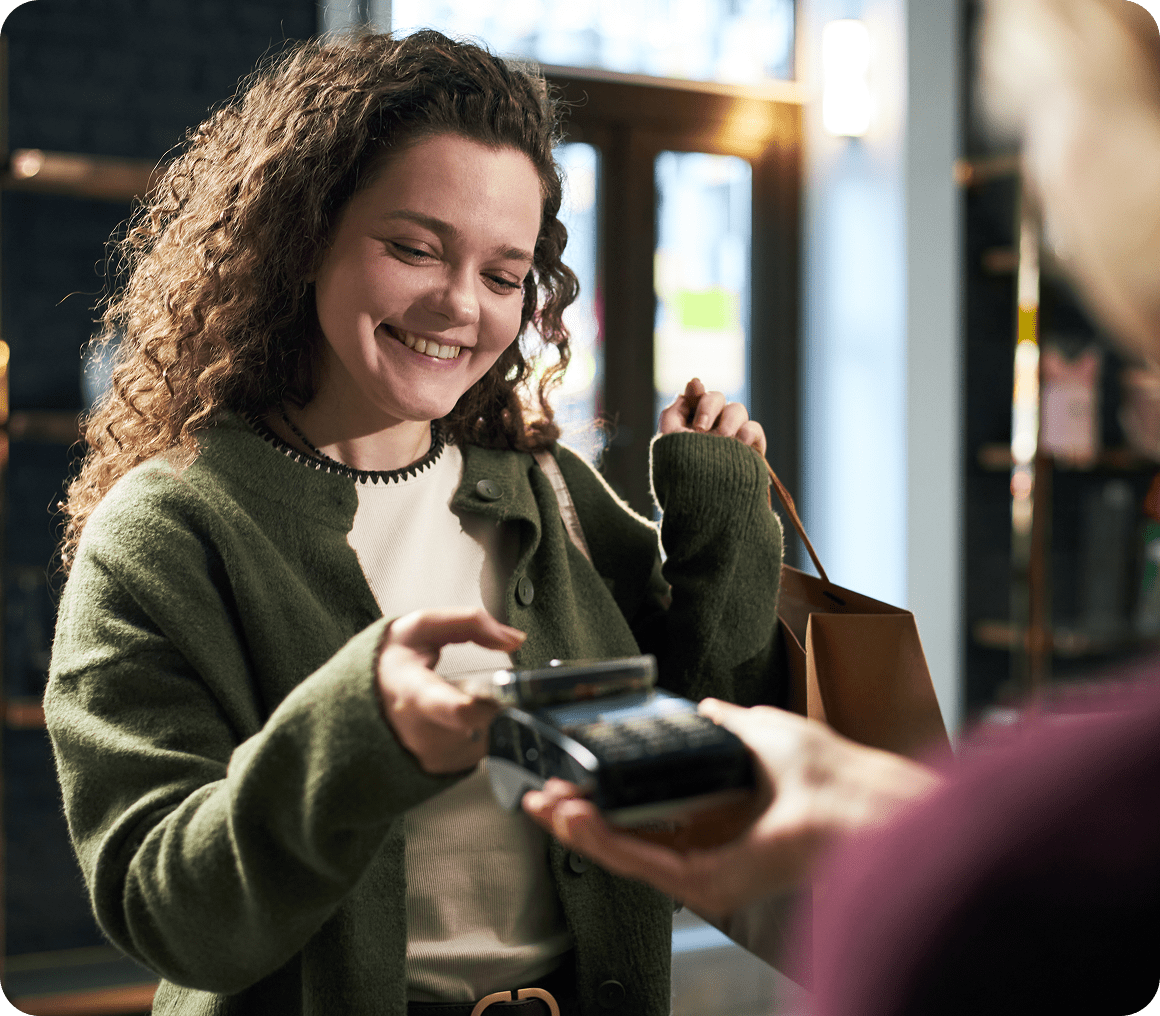 Smiling woman making a mobile payment