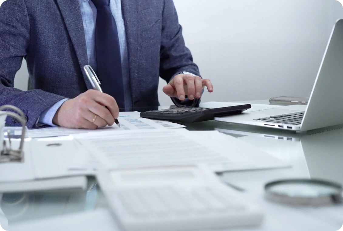 Businessman working with calculator and laptop